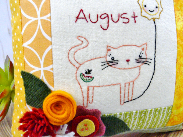 kitty cat holding the month of august hot balloon