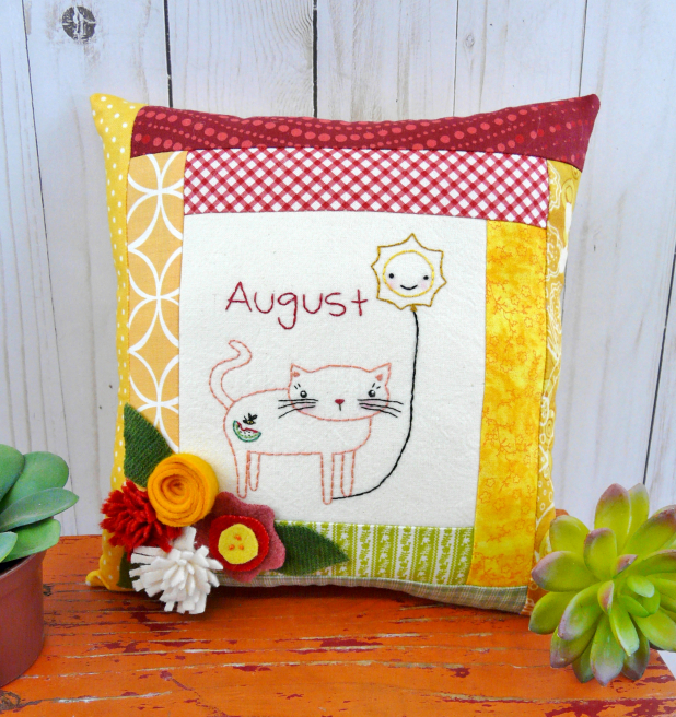 kitty cat holding the month of august hot balloon