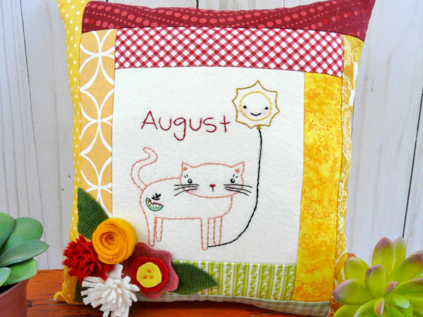 kitty cat holding the month of august hot balloon