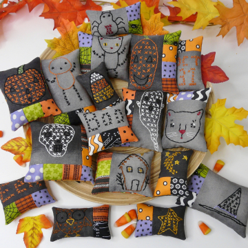Halloween embroidery patchwork ornaments on dark fabric pattern